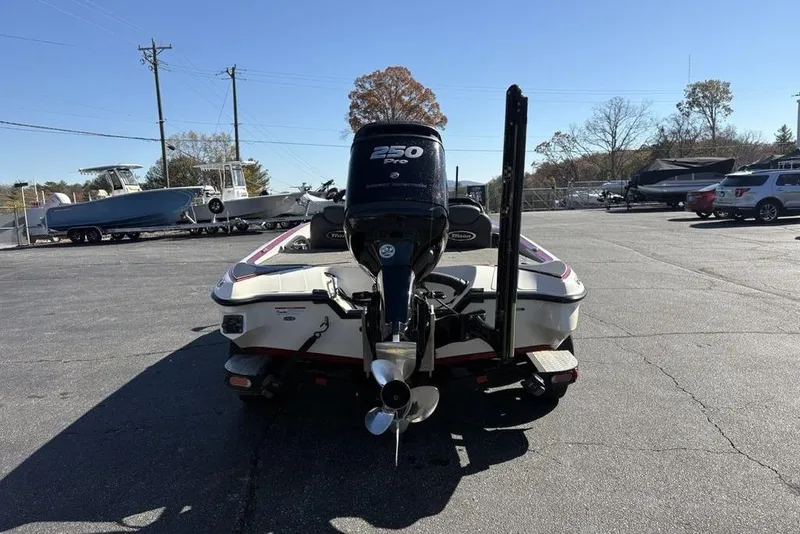 Slide: The Image of 2018 Triton 20 TrX Patriot boat with 250 Pro engine in a parking lot. - 7