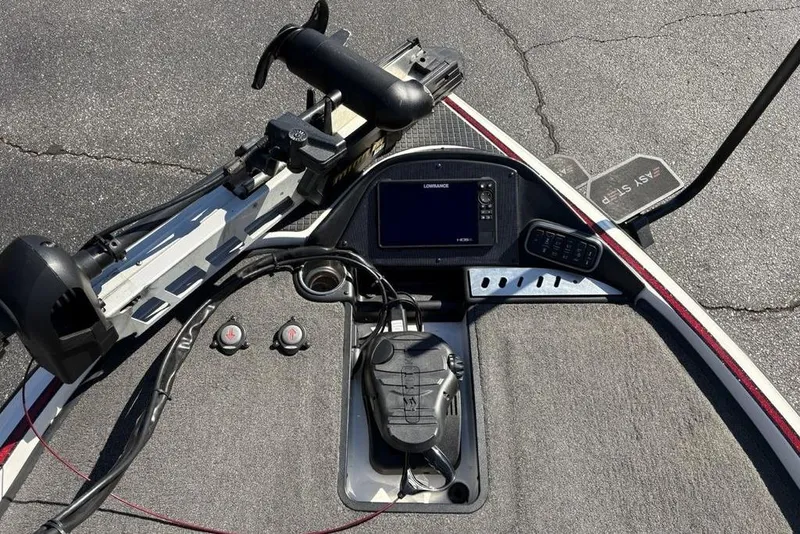 Slide: The Image of 2018 Triton 20 TrX Patriot boat dashboard with Lowrance electronics and foot pedal controls. - 9