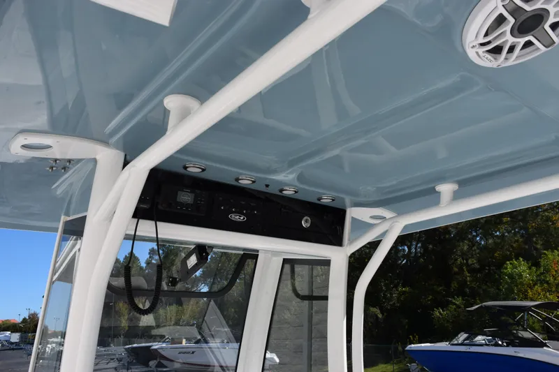 Slide: The Image of 2026 Sea Hunt Gamefish 25 boat interior with blue ceiling and speaker system. - 10