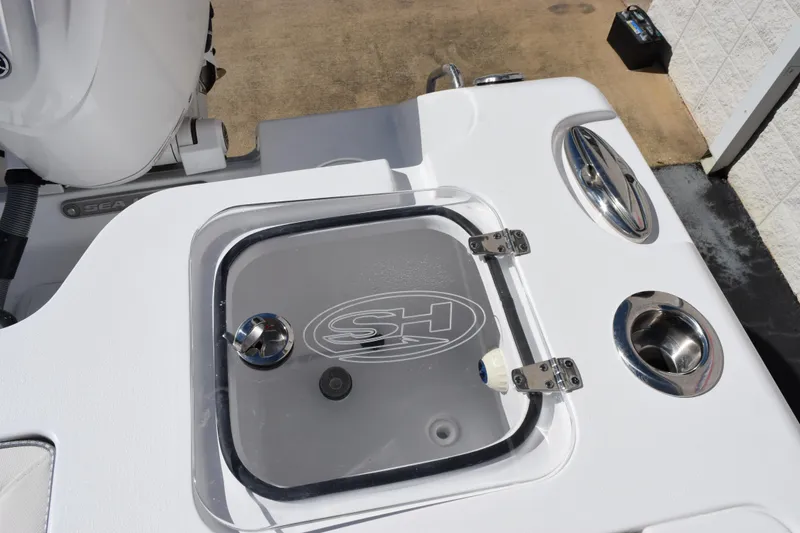 Slide: The Image of 2026 Sea Hunt Gamefish 25 boat deck with storage compartment and stainless steel fixtures. - 15