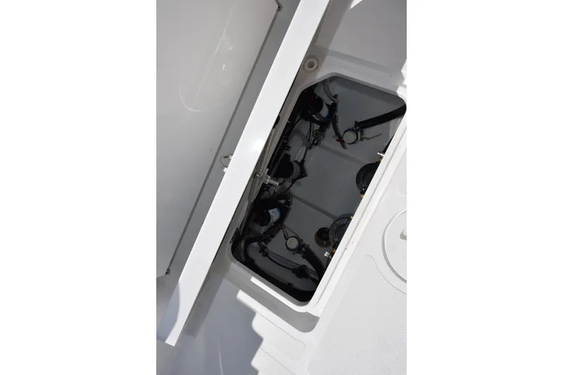 Slide: The Image of Open hatch of 2026 Sea Hunt Gamefish 25 showing internal components and wiring. - 16