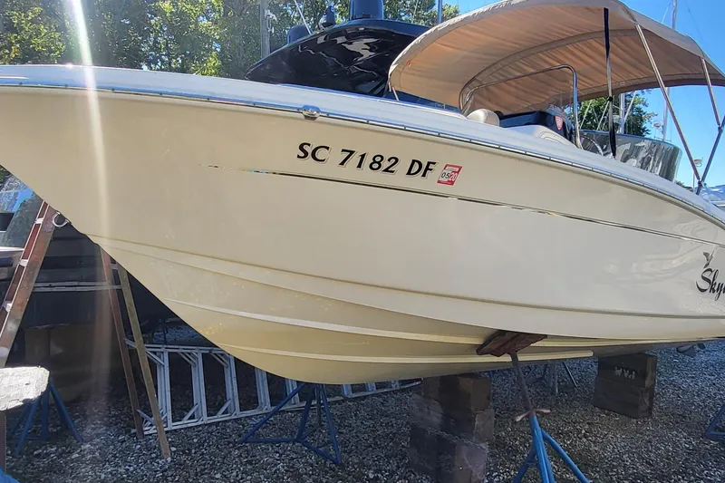 Slide: The Image of 2017 Scout 215 XSF boat on stands, side view with registration number. - 0