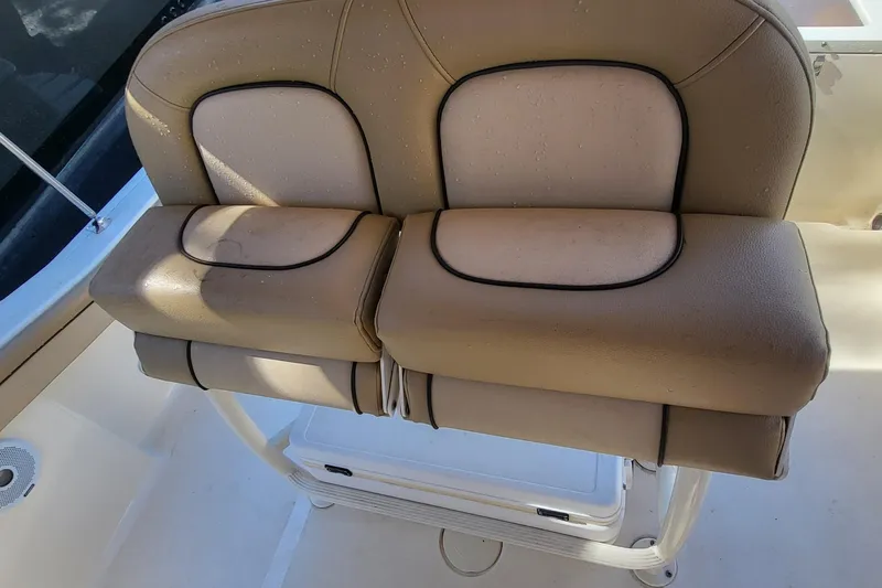Slide: The Image of 2017 Scout 215 XSF boat seat with beige upholstery and black trim. - 4