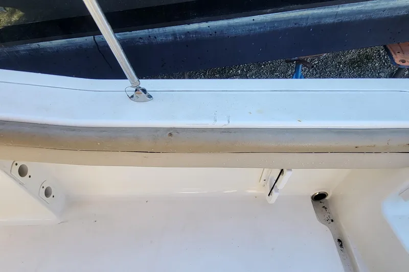 Slide: The Image of 2017 Scout 215 XSF boat interior detail with railing and drainage. - 5