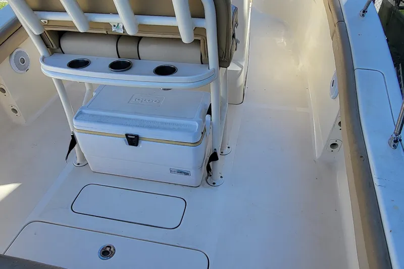 Slide: The Image of 2017 Scout 215 XSF boat interior with cooler and rod holders. - 6