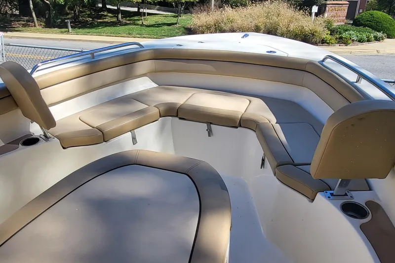 Slide: The Image of 2017 Scout 215 XSF boat interior with tan cushioned seating and cup holders. - 8