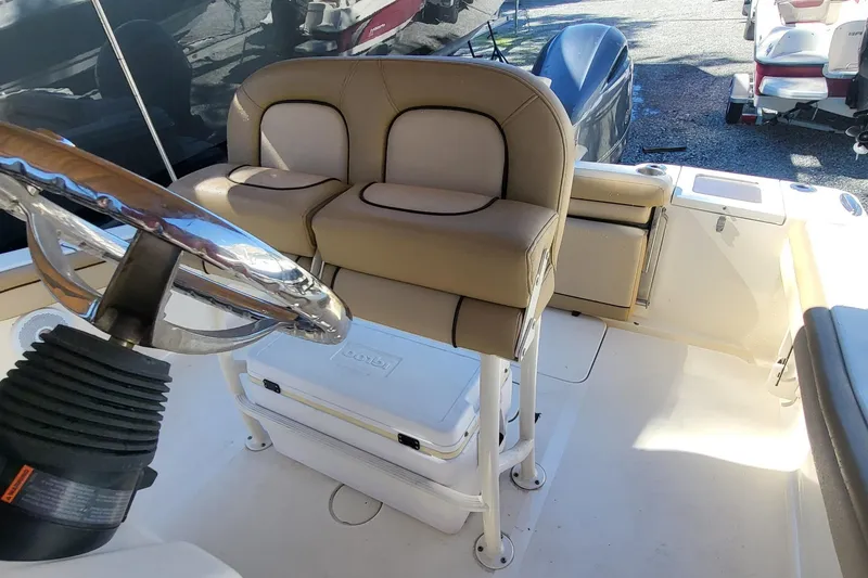 Slide: The Image of 2017 Scout 215 XSF boat interior with steering wheel and seating. - 9