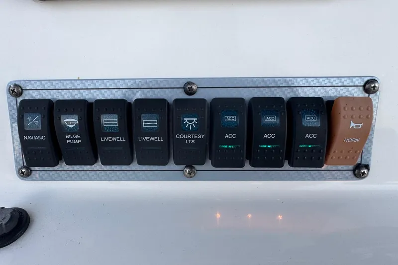 Slide: The Image of Control panel of 2023 Key West 189 FS boat with labeled switches. - 12