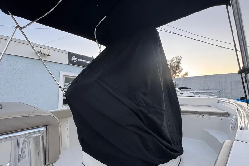 Slide: The Image of 2023 Key West 189 FS boat with covered console under a canopy at sunset. - 24