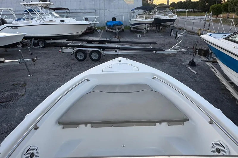 Slide: The Image of 2023 Key West 189 FS boat in a marina with other boats and trailers. - 5