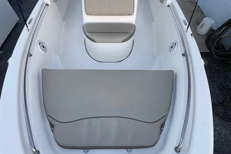 Slide: The Image of 2023 Key West 189 FS boat interior with cushioned seating and stainless steel railings. - 7