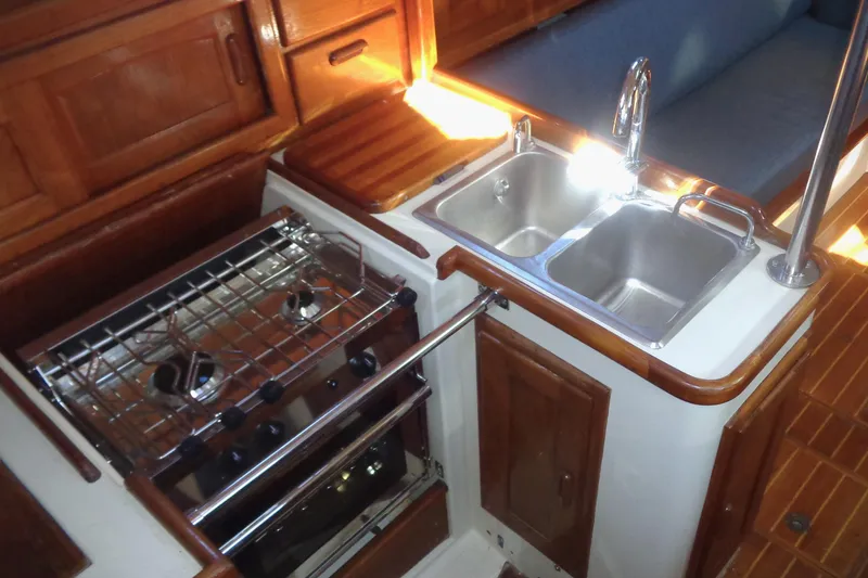 Slide: The Image of Galley kitchen in 1992 Pacific Seacraft 34 sailboat with stove and double sink. - 4
