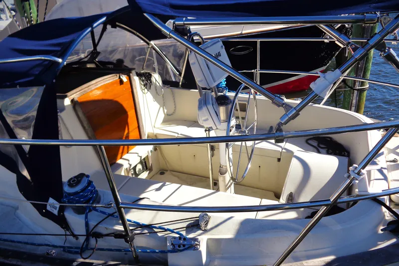 Slide: The Image of Cockpit of a 1992 Pacific Seacraft 34 sailboat with steering wheel and seating. - 5