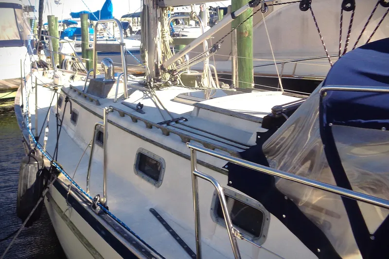 Slide: The Image of 1992 Pacific Seacraft 34 sailboat docked, featuring sleek design and sturdy railings. - 6