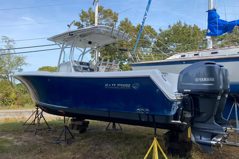 Slide: The Image of 2013 Sailfish 290 CC boat with Yamaha engines on stands, side view. - 1