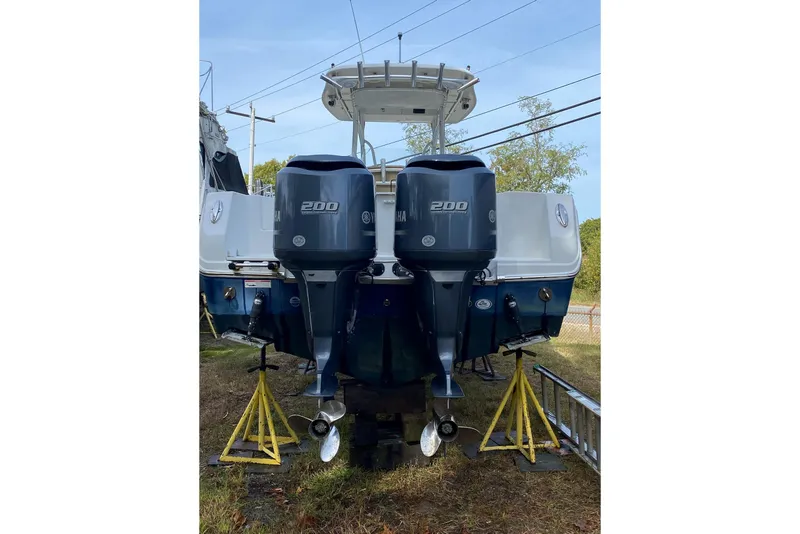 Slide: The Image of 2013 Sailfish 290 CC boat with dual Yamaha 200 engines on stands. - 4