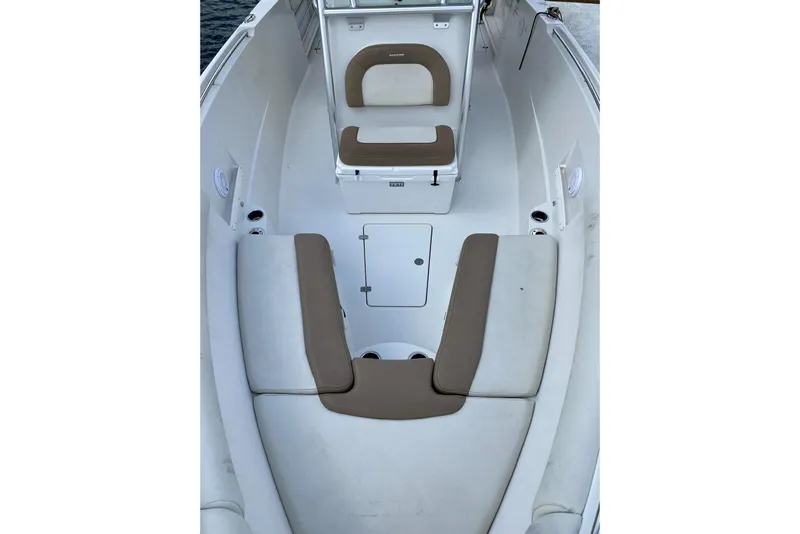 Slide: The Image of 2013 Sailfish 290 CC boat interior with cushioned seating and storage compartments. - 8