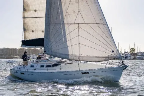 The Image of 1993 Beneteau Oceanis 350 sailboat navigating in open waters with full sails. - 0