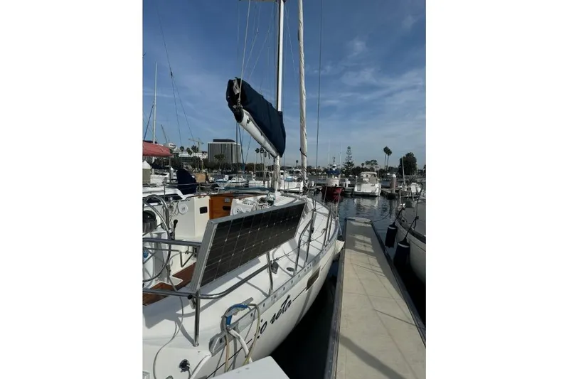 Slide: The Image of 1992 Beneteau Oceanis 350 sailboat cockpit with wooden deck and steering wheel. - 11