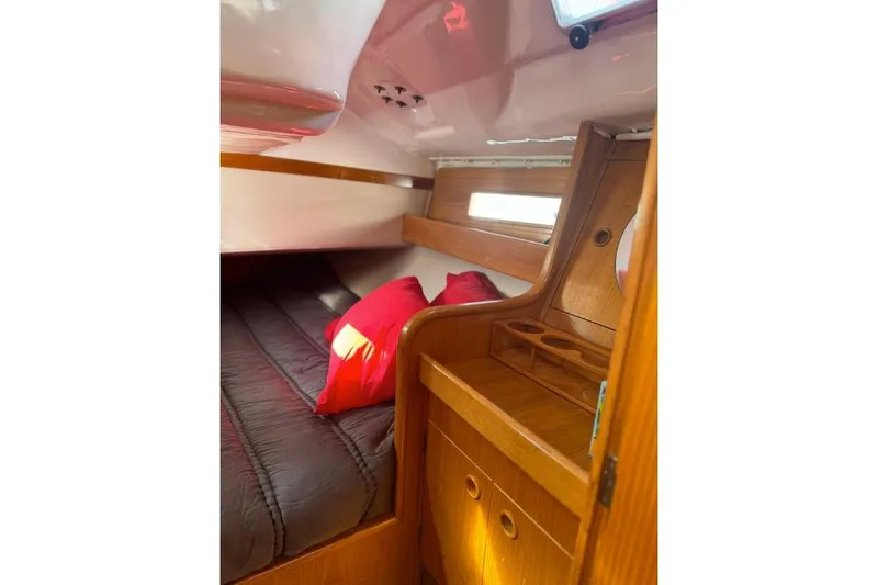 Slide: The Image of Interior of 1992 Beneteau Oceanis 350 sailboat with wooden cabinetry and seating area. - 15