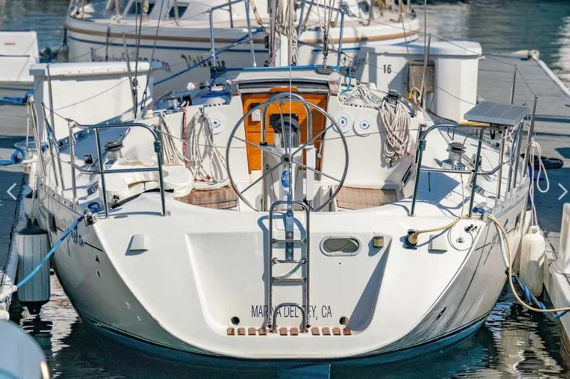 Slide: The Image of 1992 Beneteau Oceanis 350 sailboat docked in a marina, surrounded by other boats. - 2