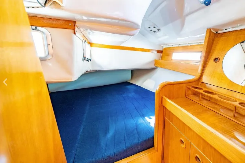 Slide: The Image of 1992 Beneteau Oceanis 350 sailboat docked in a marina, featuring a clean deck and steering wheel. - 4