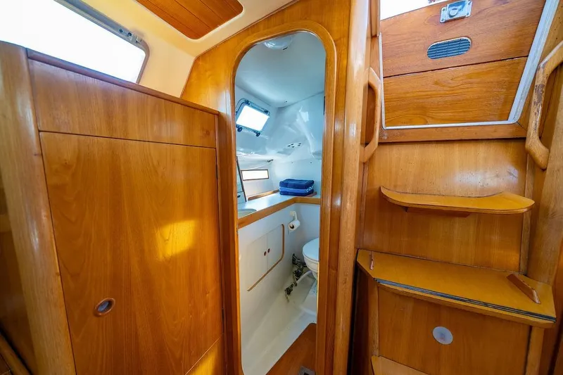 Slide: The Image of Cozy cabin interior of 1992 Beneteau Oceanis 350 sailboat with wooden furnishings. - 5