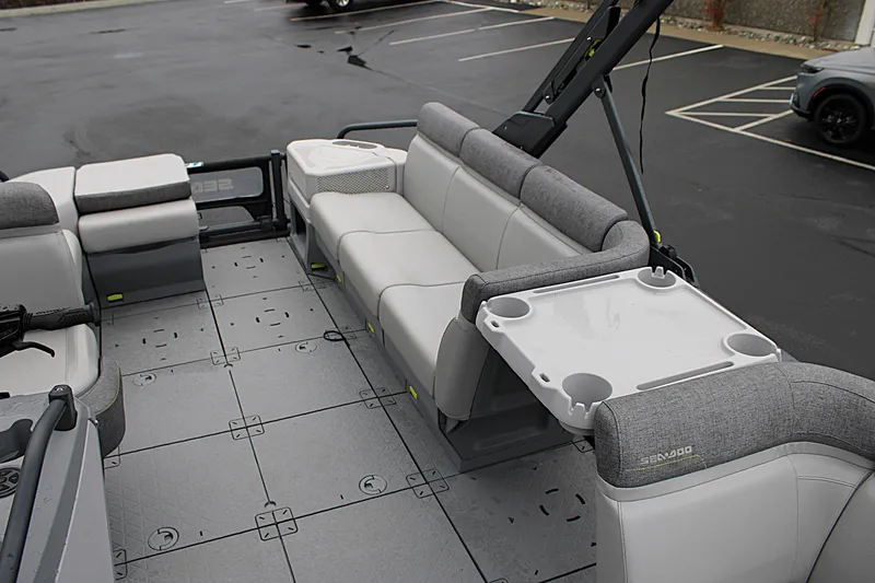 Slide: The Image of 2023 Sea-Doo Switch Cruise 21 interior with gray seating and a white table. - 15