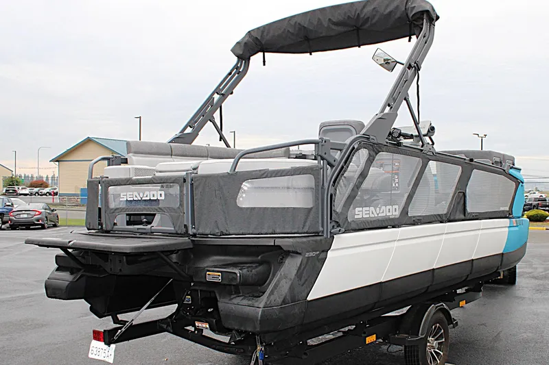Slide: The Image of 2023 Sea-Doo Switch Cruise 21 pontoon boat with canopy, parked on a trailer. - 5