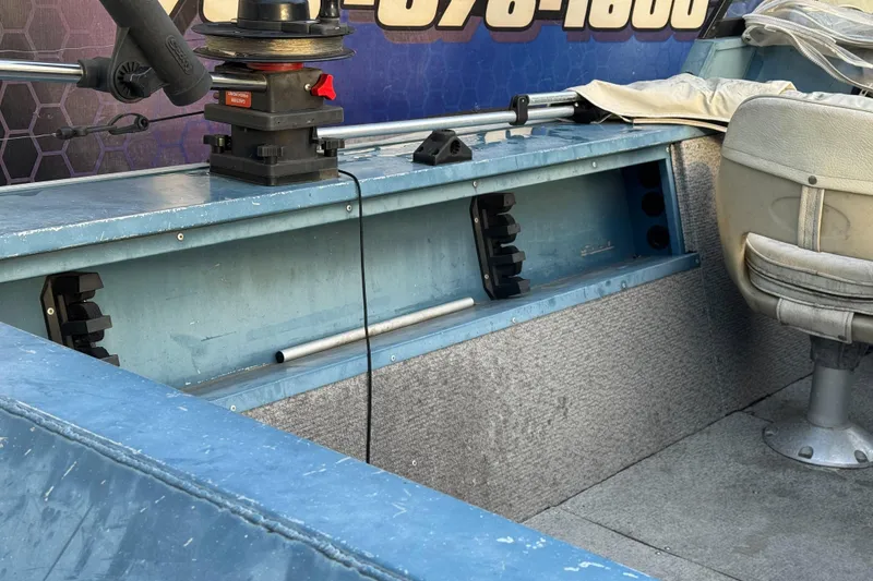 Slide: The Image of Interior of a 1998 Klamath 18 Open boat with seating and equipment. - 13