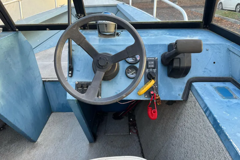 Slide: The Image of 1998 Klamath 18 Open boat cockpit with steering wheel and control panel. - 6