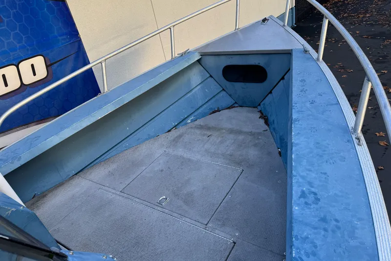 Slide: The Image of 1998 Klamath 18 Open boat interior with blue metal and carpeted flooring. - 7