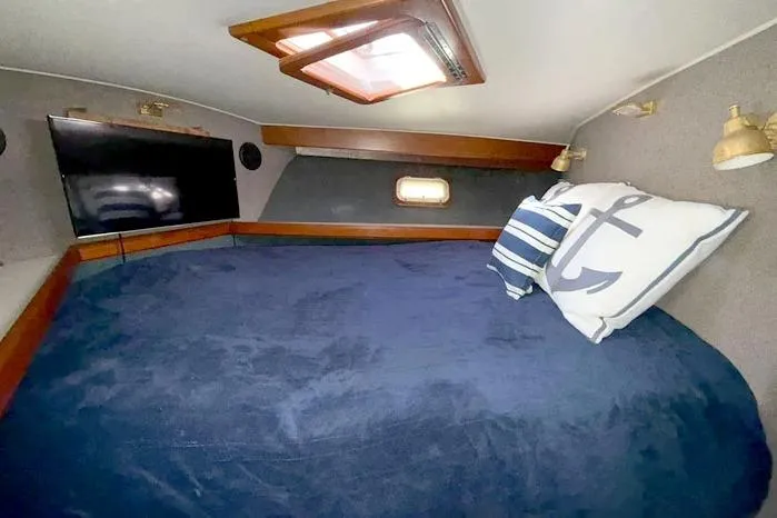 Slide: The Image of Cozy cabin interior of 1983 Egg Harbor 40 Sedan with nautical decor and skylight. - 16