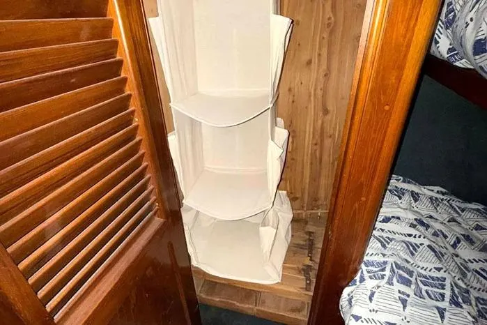 Slide: The Image of Interior of 1983 Egg Harbor 40 Sedan with wooden closet and fabric organizer. - 19