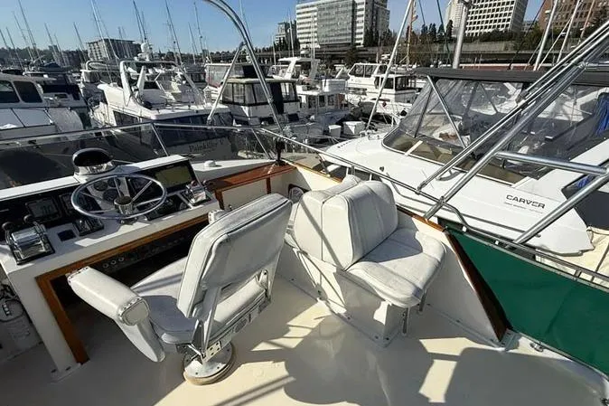 Slide: The Image of 1983 Egg Harbor 40 Sedan yacht interior with helm and seating, docked in a marina. - 3