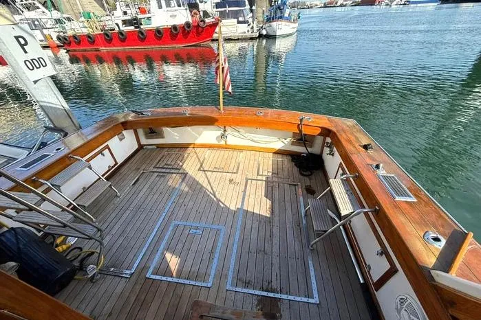 Slide: The Image of 1983 Egg Harbor 40 Sedan boat deck with wooden finish, docked in a marina. - 4