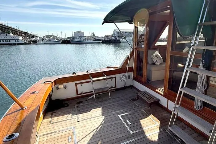 Slide: The Image of 1983 Egg Harbor 40 Sedan yacht with wooden deck, docked in a marina. - 5