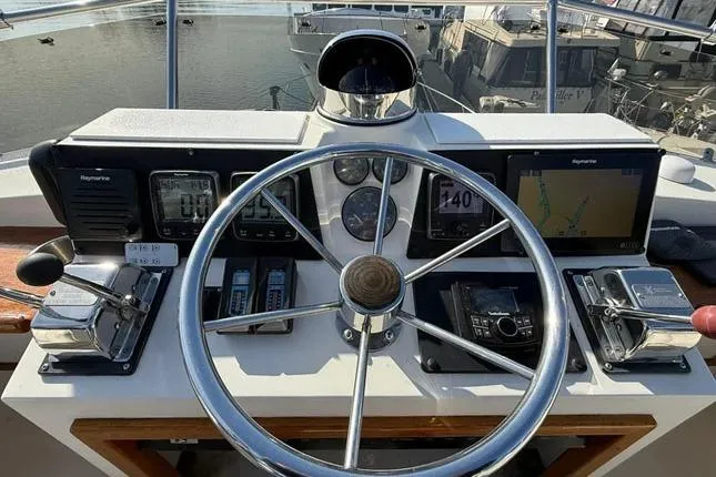 Slide: The Image of Helm of 1983 Egg Harbor 40 Sedan with navigation instruments and steering wheel. - 6