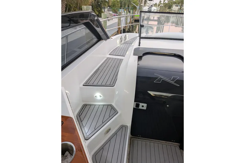 Slide: The Image of 2023 NX Boats 340 Sport Coupe deck with sleek design and modern features. - 21