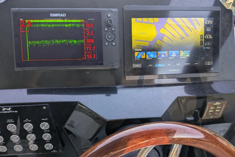 Slide: The Image of Dashboard of 2023 NX Boats 340 Sport Coupe with Simrad and Garmin displays. - 23