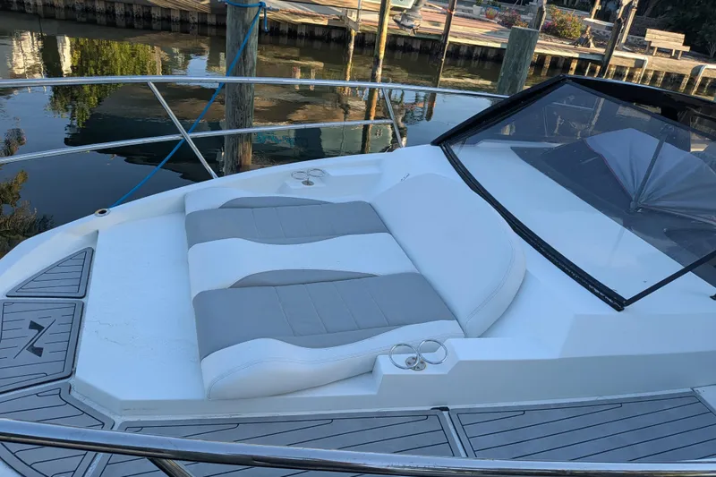 Slide: The Image of 2023 NX Boats 340 Sport Coupe with sleek deck and comfortable seating. - 25