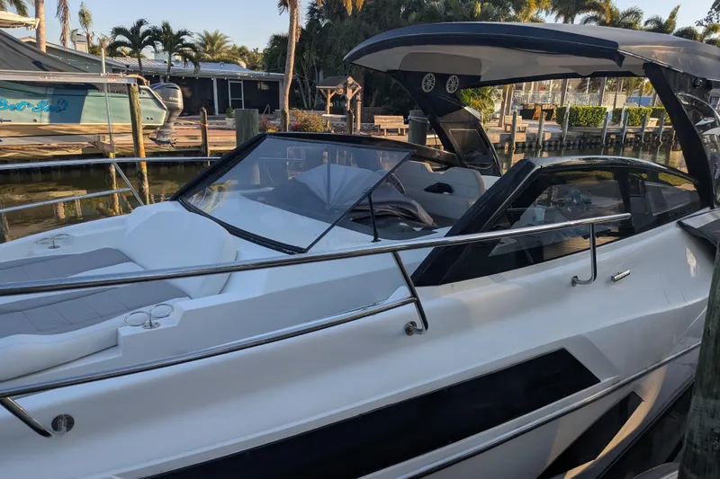 Slide: The Image of 2023 NX Boats 340 Sport Coupe docked, showcasing sleek design and modern features. - 28