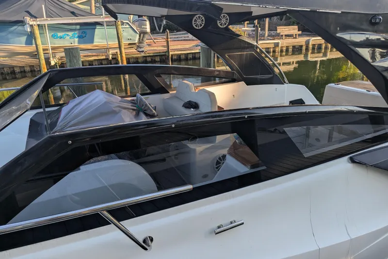 Slide: The Image of 2023 NX Boats 340 Sport Coupe docked, showcasing sleek design and modern features. - 30