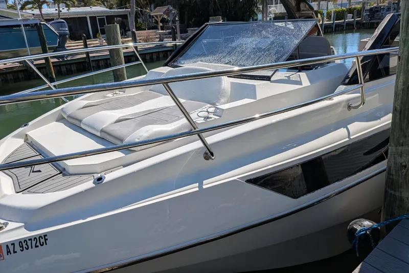 Slide: The Image of 2023 NX Boats 340 Sport Coupe docked, showcasing sleek design and modern features. - 43