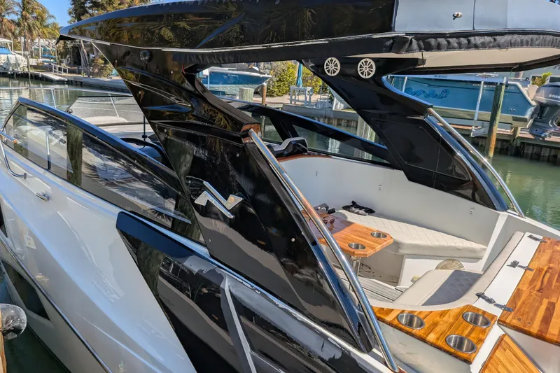 Slide: The Image of 2023 NX Boats 340 Sport Coupe, sleek design, luxurious interior, docked at marina. - 47