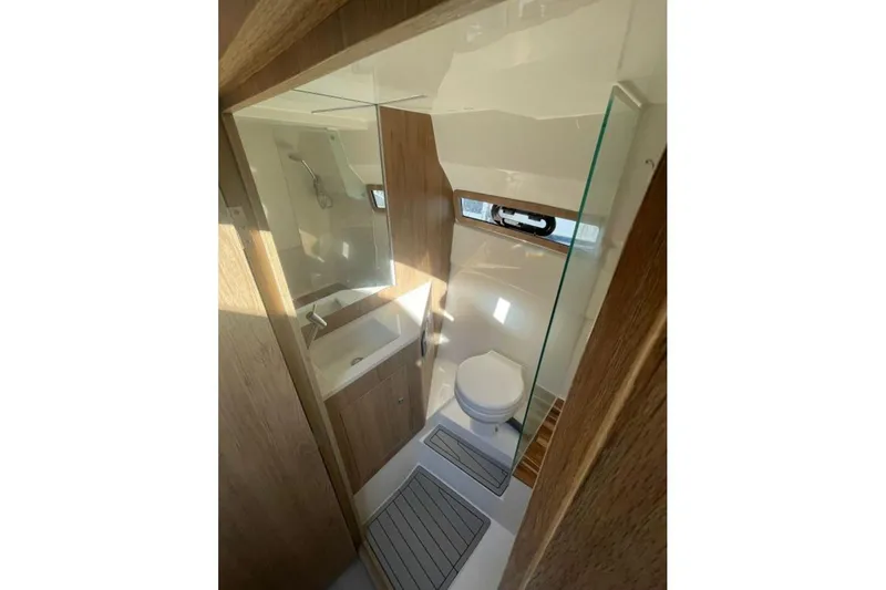 Slide: The Image of 2023 NX Boats 340 Sport Coupe bathroom with modern fixtures and wooden accents. - 6