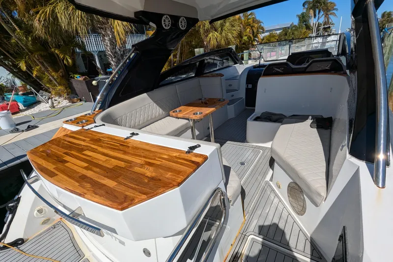 Slide: The Image of 2023 NX Boats 340 Sport Coupe interior with elegant seating and wooden accents. - 65