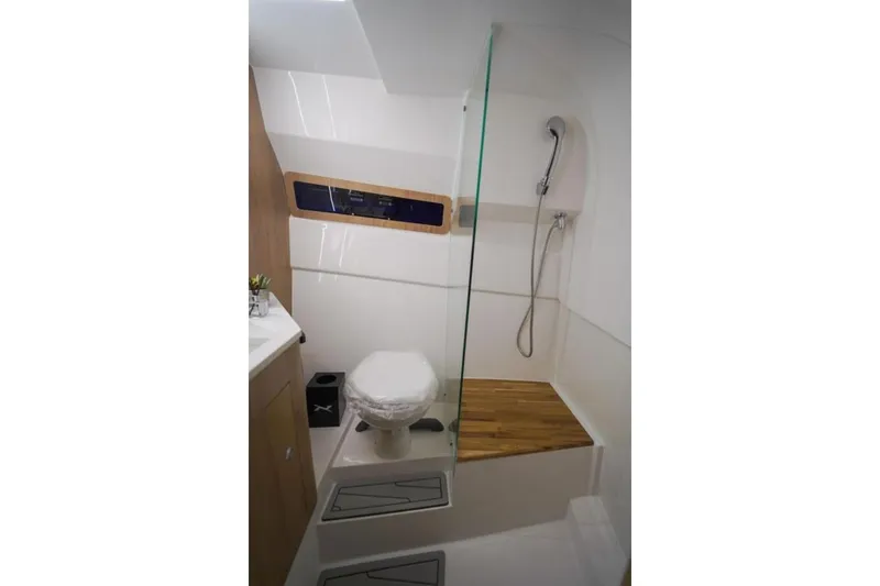 Slide: The Image of 2023 NX Boats 340 Sport Coupe bathroom with shower and toilet. - 7