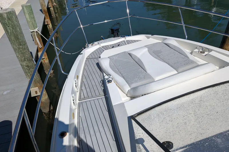 Slide: The Image of 2023 NX Boats 340 Sport Coupe with sunpad, docked at marina. - 76