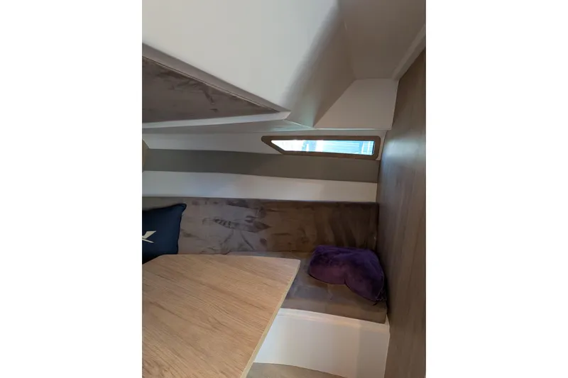 Slide: The Image of Interior cabin of 2023 NX Boats 340 Sport Coupe, featuring seating and a window. - 79